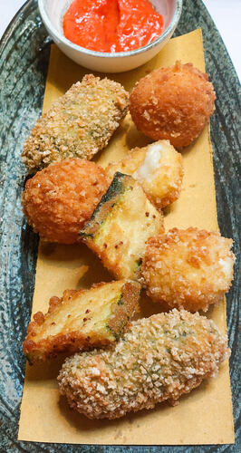Close up of fried zucchini, suppli and fried mozzarella with