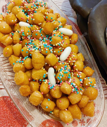 Strufoli, typical italian christmas sweets, completely cover