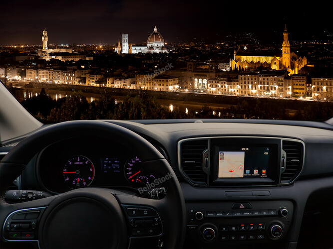View of a car dashboard with a navigation unit traveling to 