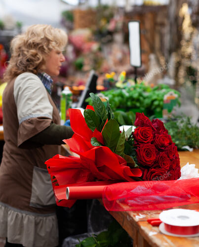 Florist with professional clothing in a nursery. Preparation