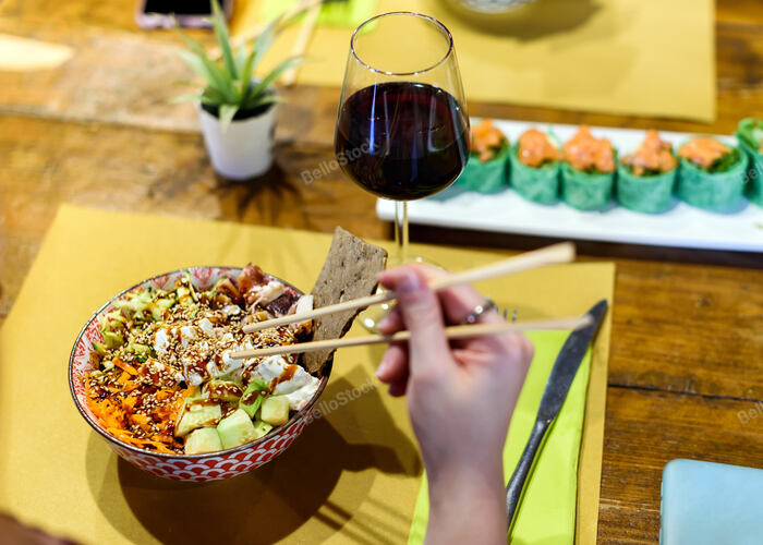 Having a poke dish in a restaurant. A dish served in a bowl 