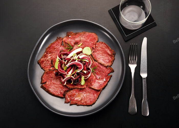 Sliced cold roast beef with fresh radicchio salad in a moder