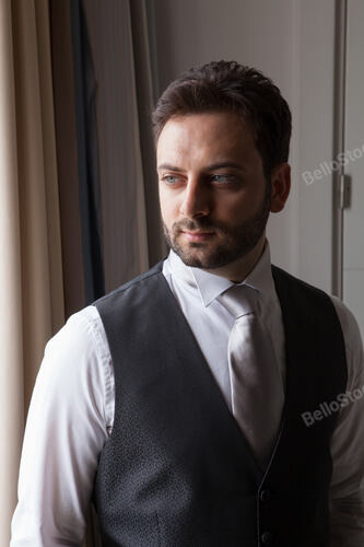 Young Italian groom with beard, brown hair and green eyes be