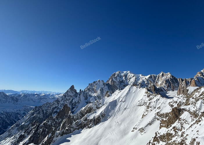 Breathtaking view of snow capped Mont Blanc massif under cle