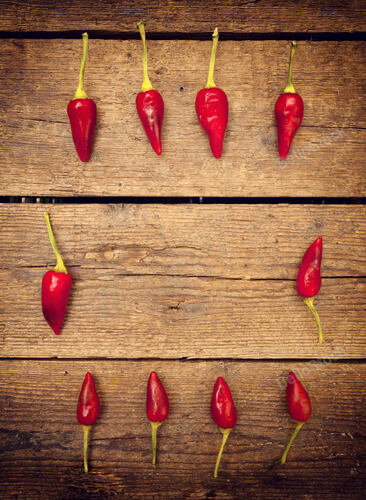 Hot chili peppers Salentini on wooden table