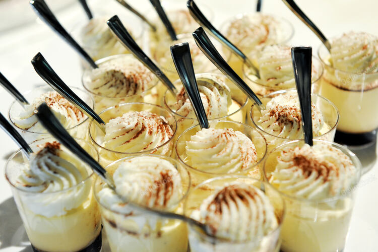 Close-up of mouth watering Desserts in small glasses with spoon. — stock photo
