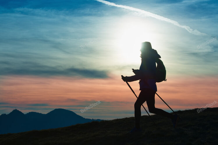 Silhouette of a girl on a mountain during a religious trek i