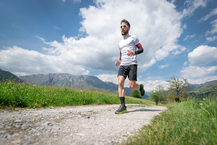 Training of a mountain marathon runner on the country road