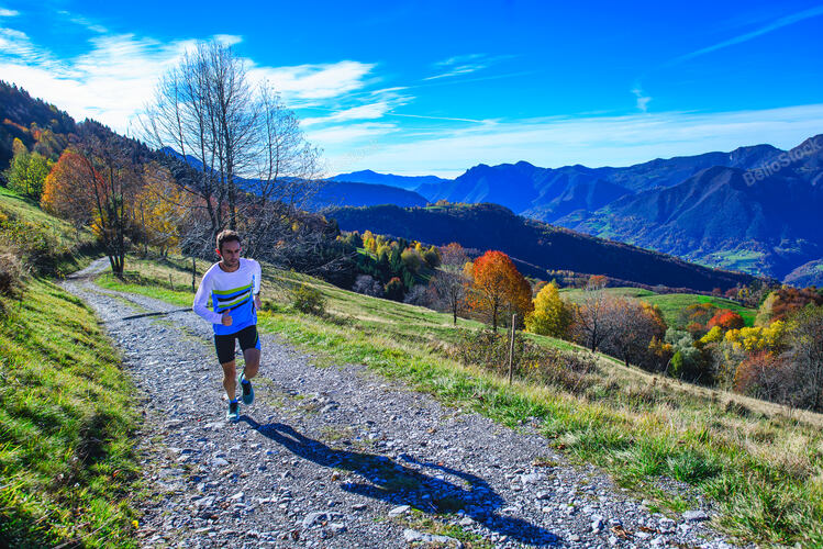 A mountain running athlete trains on the dirt road