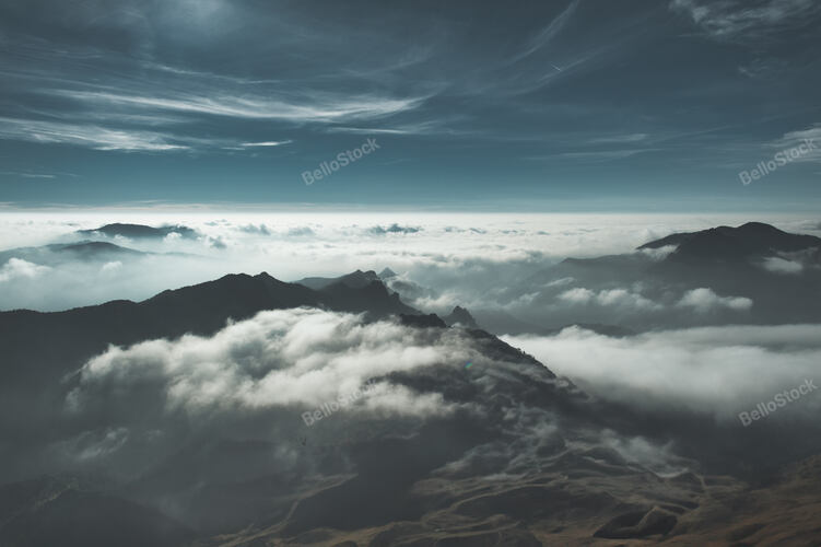 Horizontal abstract mountain landscape with clouds and mists
