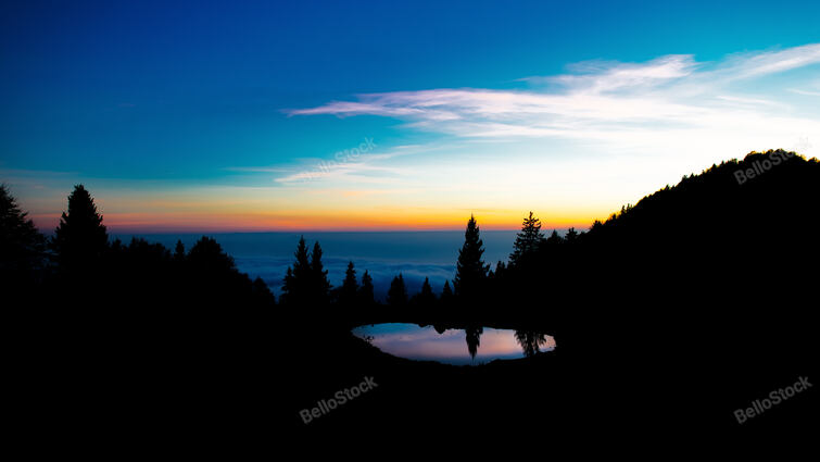 After sunset the colors in an alpine landscape with a small 