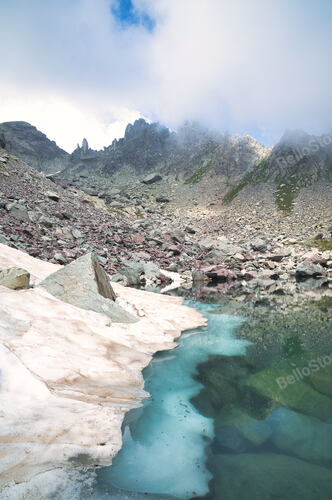 Chilling in an alpine lake with last snow of late spring