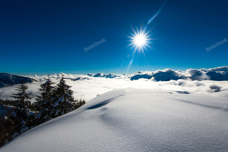 Big snowfall in the Alps landscape with clouds in the valley