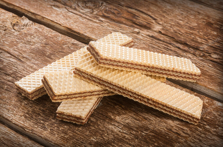 Wafers with chocolate on rustic wooden table. — stock photo