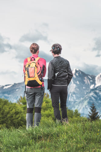Pair of women friendly women observe the mountains during an