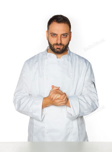 Young chef in white uniform without hat isolated on white ba
