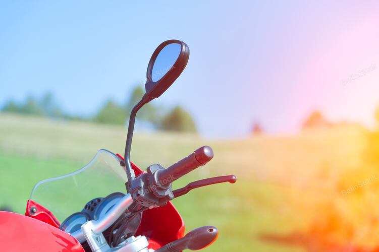 Detail of red motorcycle in the mountains in the sun